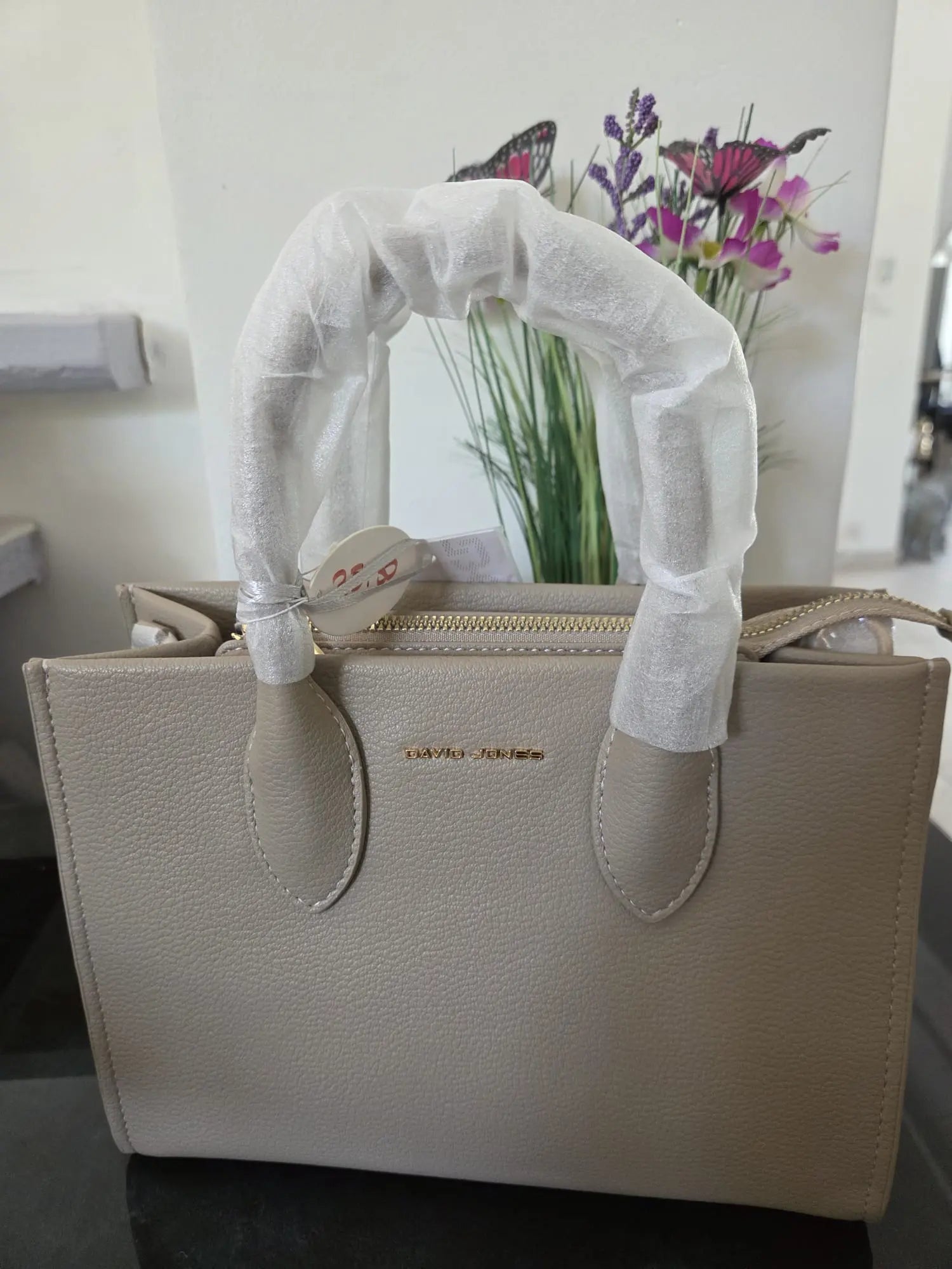Sac à main élégant David Jones en simili cuir grainé avec fermeture zippée et détails dorés, chic et moderne pour femme.